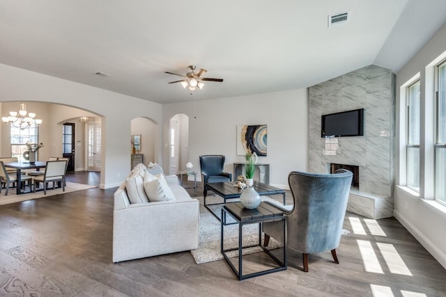 living room featuring a wealth of natural light, a fireplace, and hardwood / wood-style flooring