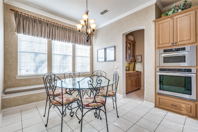 dining area featuring crown molding, a chandelier, and light tile patterned flooring