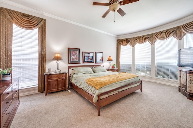 carpeted bedroom with ceiling fan and ornamental molding