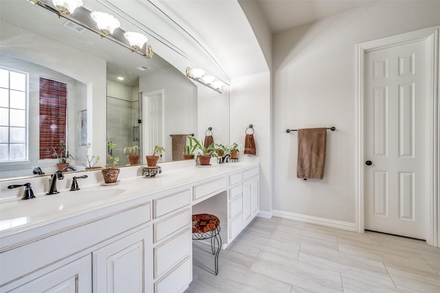 bathroom with vanity and a shower with door