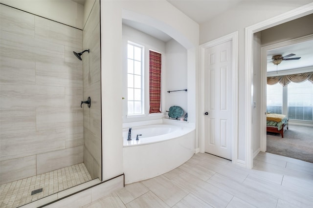 bathroom featuring independent shower and bath, a wealth of natural light, and ceiling fan