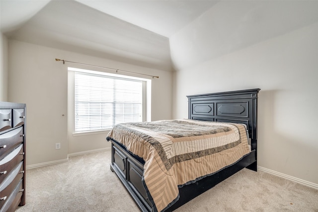 carpeted bedroom featuring vaulted ceiling