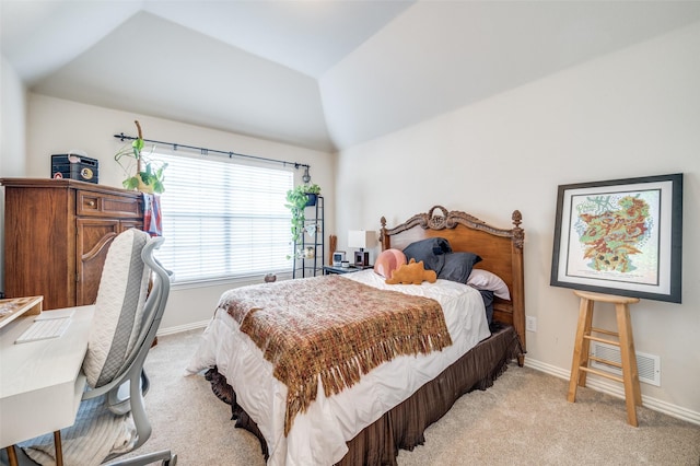 carpeted bedroom with lofted ceiling