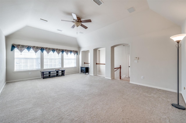 unfurnished living room featuring light carpet, vaulted ceiling, and ceiling fan