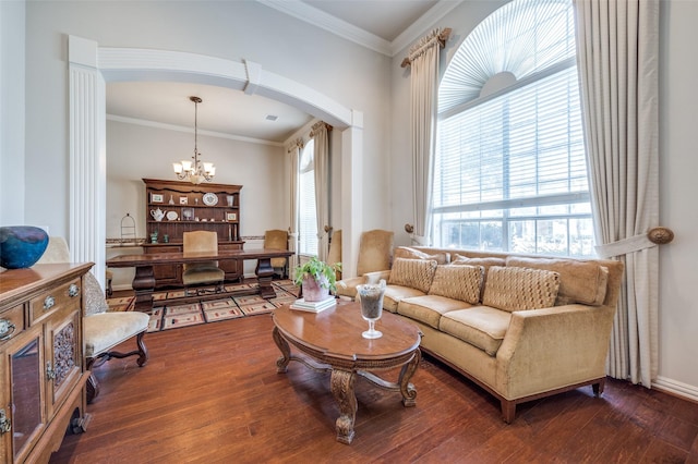 living room featuring a notable chandelier, ornamental molding, and dark hardwood / wood-style floors