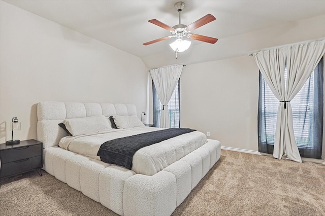 bedroom with light carpet, ceiling fan, and vaulted ceiling