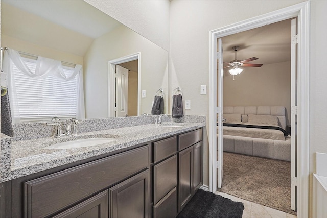 bathroom featuring ceiling fan, double vanity, a sink, and connected bathroom