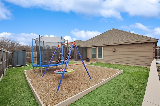 view of jungle gym featuring a yard, a trampoline, and a fenced backyard