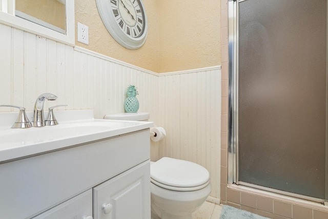 bathroom featuring walk in shower, vanity, and toilet