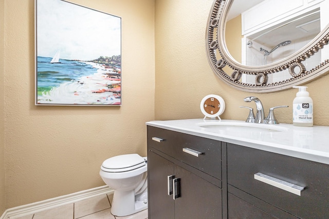 bathroom featuring vanity, tile patterned floors, and toilet