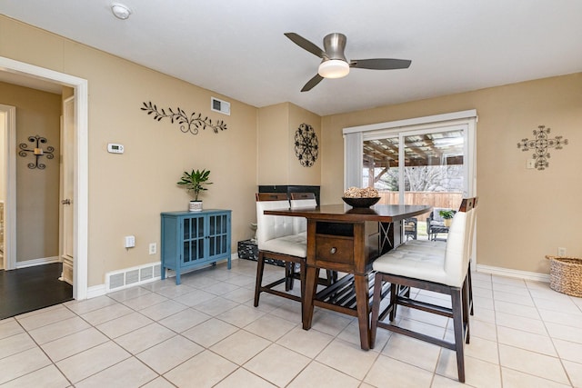 dining space with ceiling fan and light tile patterned floors