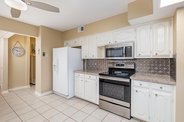 kitchen with stainless steel appliances, white cabinetry, light tile patterned floors, and backsplash