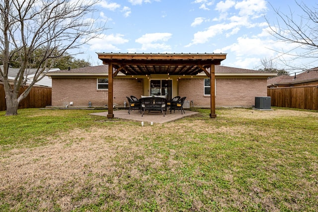 back of property featuring central AC unit, a yard, and a patio area