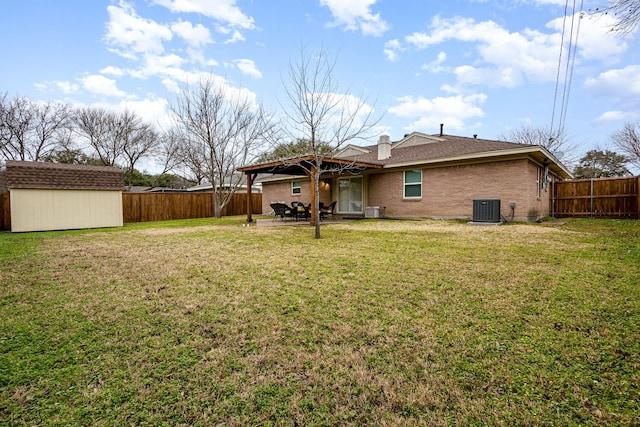 rear view of house with cooling unit, a storage shed, a patio area, and a lawn