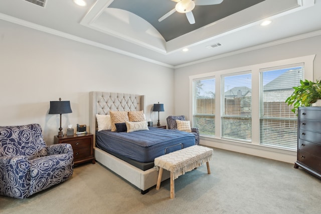 bedroom featuring crown molding, a tray ceiling, carpet floors, and ceiling fan