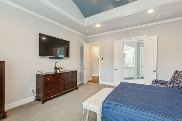 carpeted bedroom featuring ornamental molding and ensuite bath