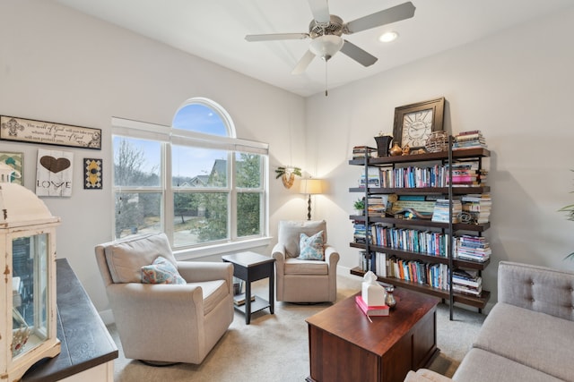 living room featuring light colored carpet and ceiling fan