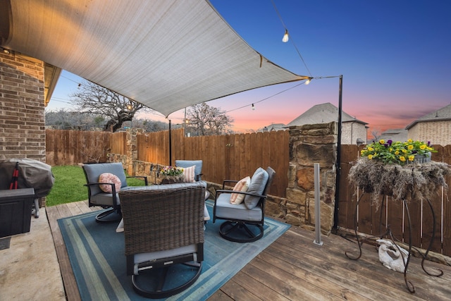 deck at dusk featuring area for grilling