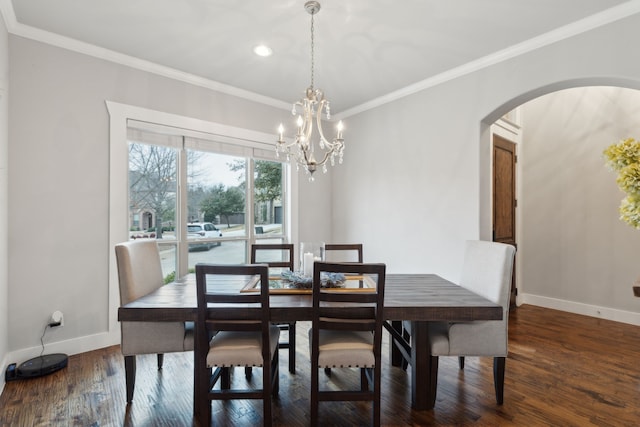 dining room with a notable chandelier, crown molding, and dark wood-type flooring