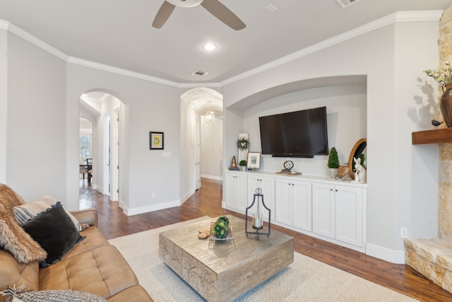 living room with crown molding, wood-type flooring, and ceiling fan