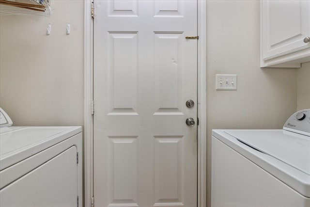 laundry room with cabinets and washer and clothes dryer