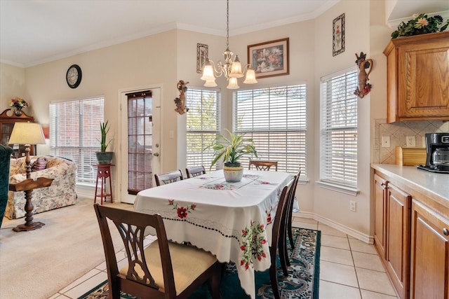 tiled dining space with an inviting chandelier and crown molding