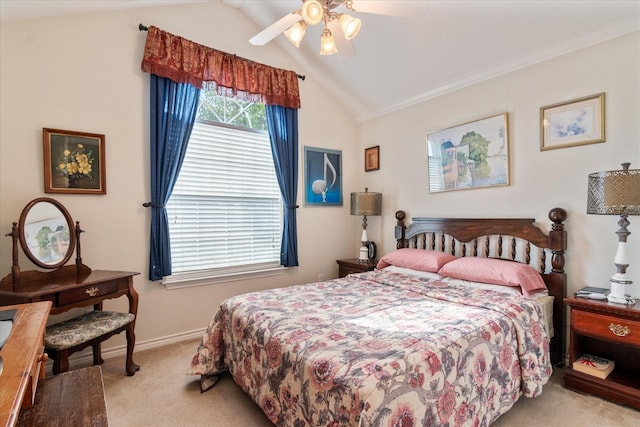 carpeted bedroom with ornamental molding, lofted ceiling, and ceiling fan