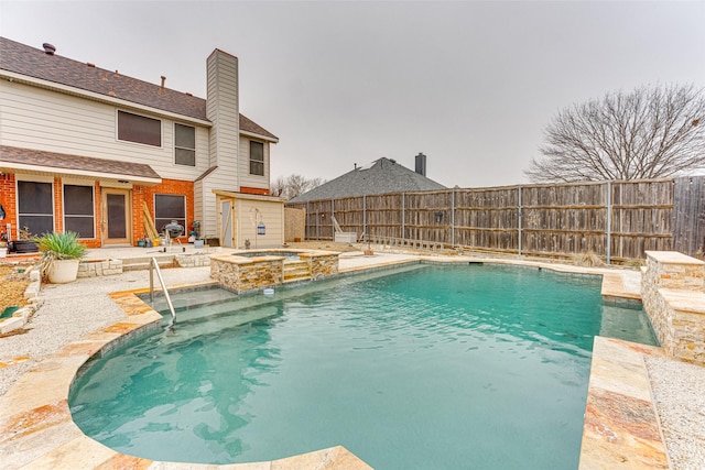 view of swimming pool featuring an in ground hot tub, pool water feature, and a patio area