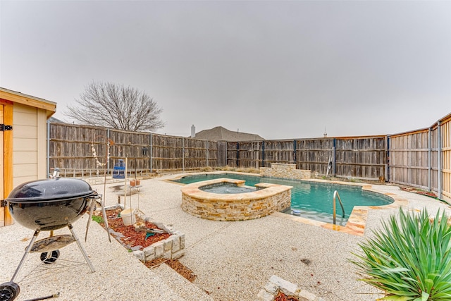 view of swimming pool featuring an in ground hot tub and grilling area