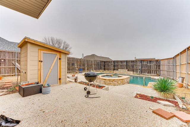 view of swimming pool featuring a shed, a patio, an in ground hot tub, and a grill