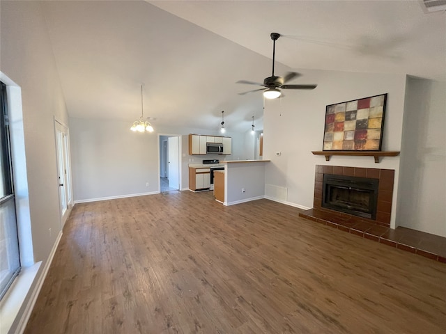 unfurnished living room featuring dark hardwood / wood-style flooring, high vaulted ceiling, ceiling fan with notable chandelier, and a fireplace