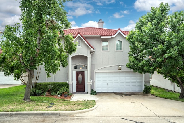 view of front facade featuring a tiled roof, concrete driveway, stucco siding, a chimney, and a garage