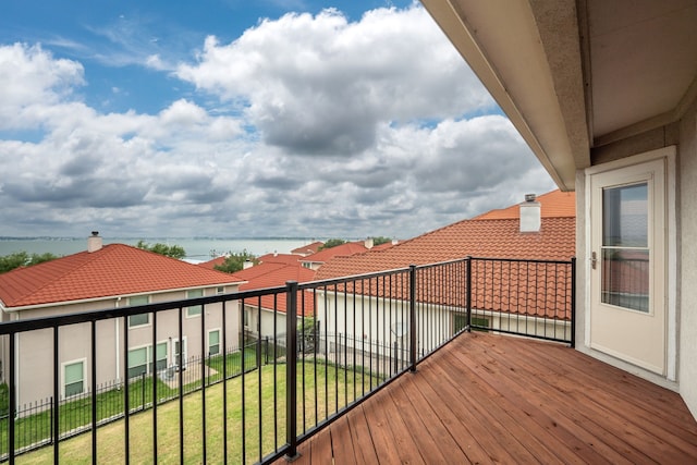 deck featuring a water view and a lawn