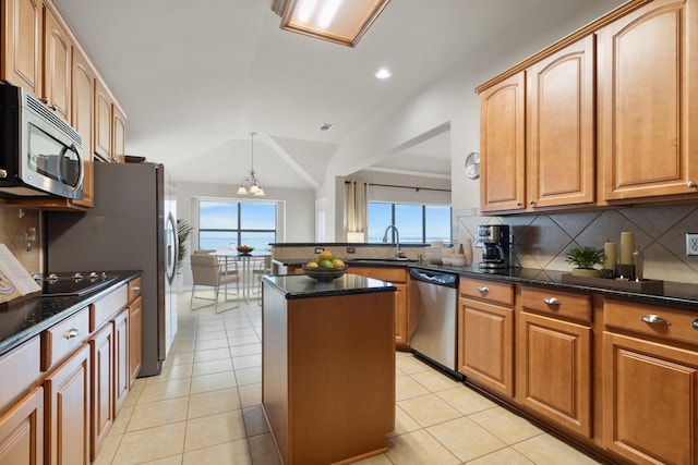 kitchen with light tile patterned flooring, decorative backsplash, and appliances with stainless steel finishes