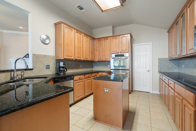 kitchen with a sink, visible vents, appliances with stainless steel finishes, and dark stone countertops