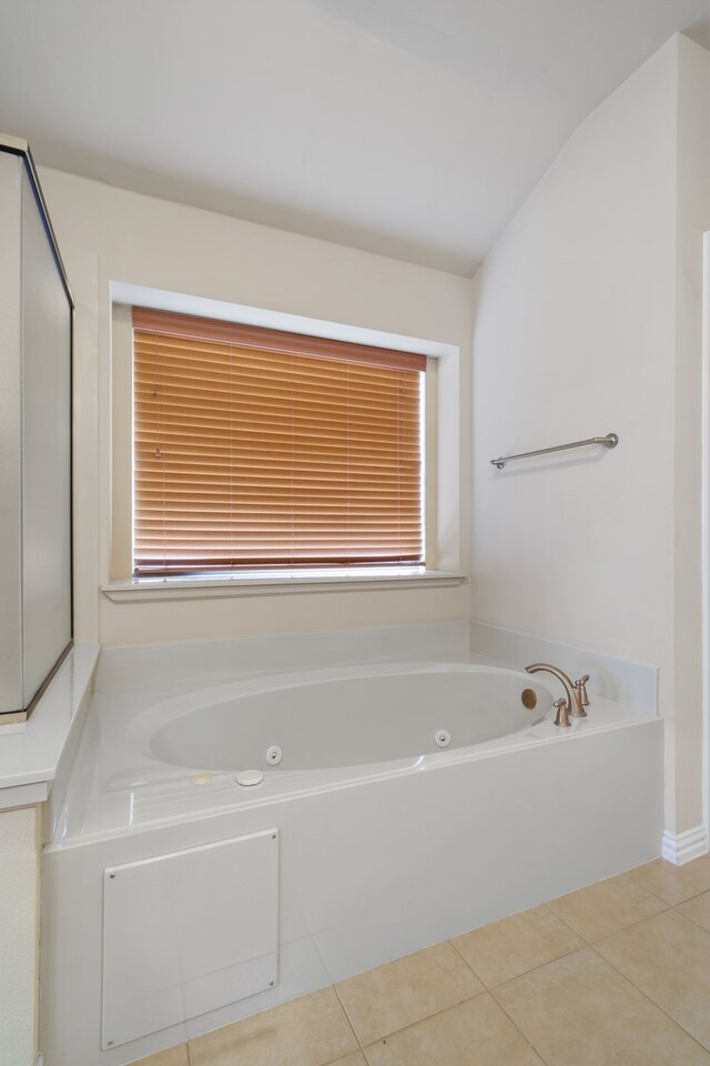 bathroom with vanity, tile patterned flooring, and a washtub