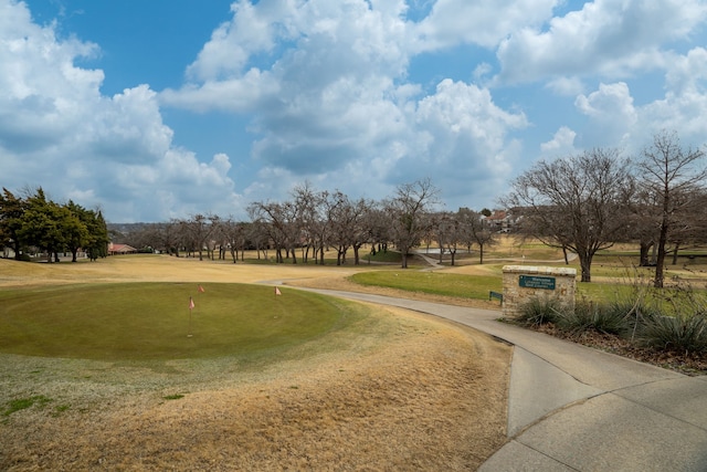 view of property's community with a lawn