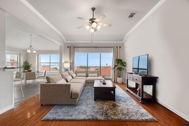 living room with dark wood-type flooring, ceiling fan, and crown molding