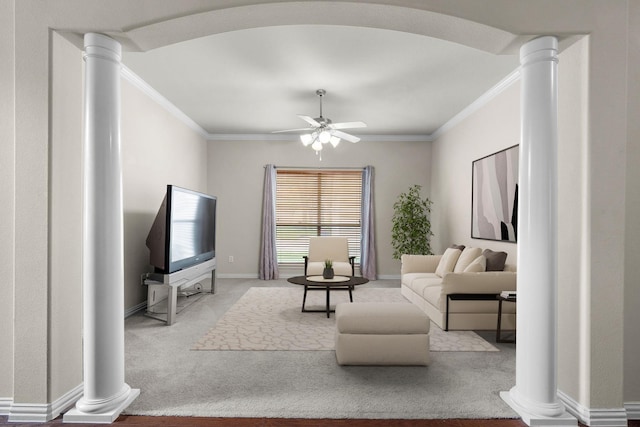 carpeted living area featuring baseboards, decorative columns, ceiling fan, and ornamental molding