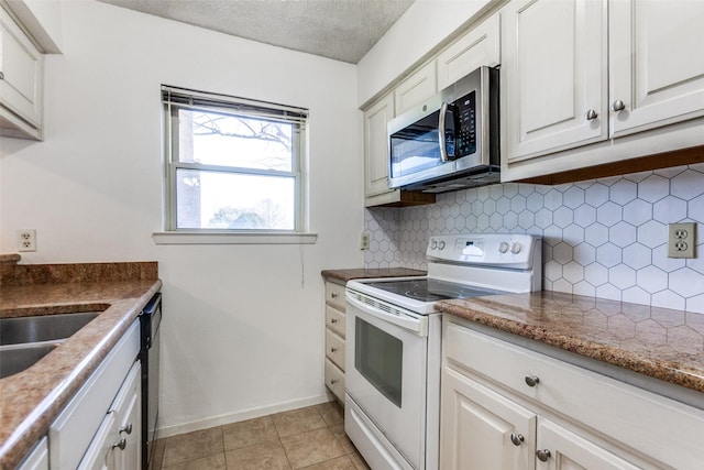 kitchen with light tile patterned flooring, white electric range, white cabinetry, tasteful backsplash, and a textured ceiling