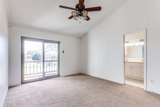 carpeted empty room with lofted ceiling, ceiling fan, crown molding, and a textured ceiling