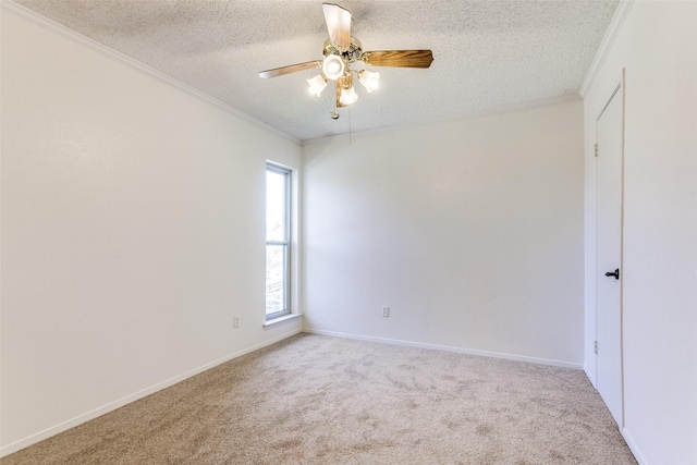 carpeted spare room with crown molding, a textured ceiling, and ceiling fan