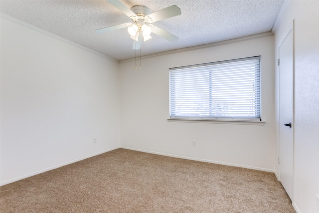 carpeted spare room with crown molding, ceiling fan, and a textured ceiling