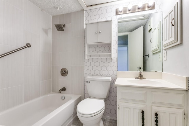 full bathroom featuring tile walls, tiled shower / bath combo, vanity, a textured ceiling, and toilet