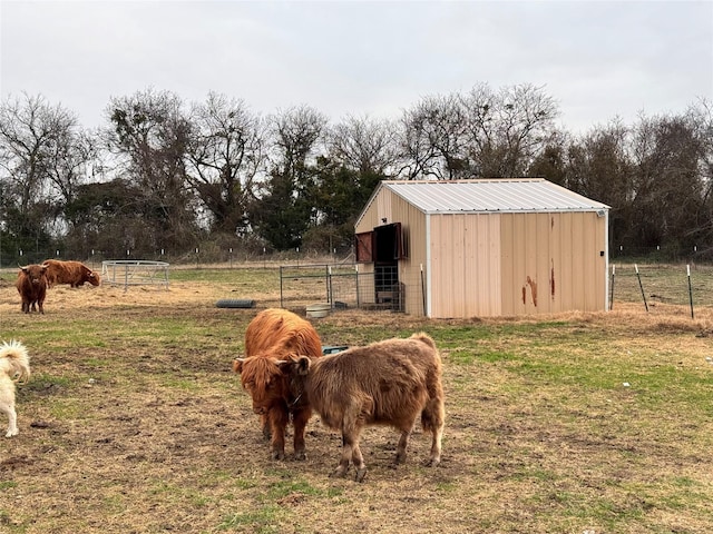 view of horse barn with a rural view