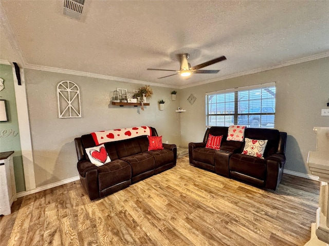 living room with hardwood / wood-style flooring, ceiling fan, crown molding, and a textured ceiling