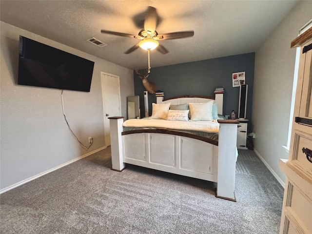 unfurnished bedroom featuring ceiling fan, carpet floors, and a textured ceiling