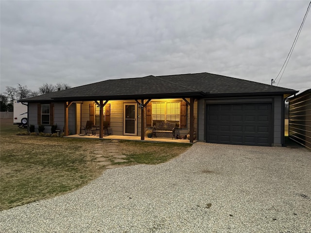 ranch-style home with a garage and a front lawn