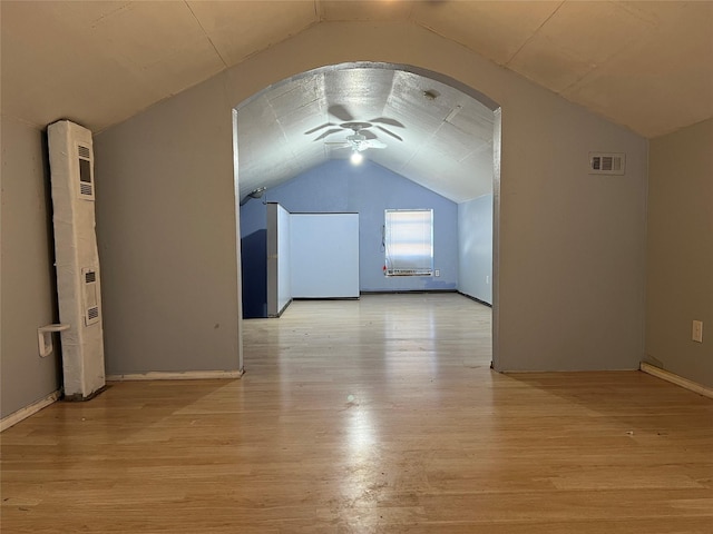 additional living space with vaulted ceiling, light hardwood / wood-style floors, and ceiling fan