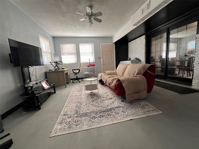 living room with ceiling fan and a textured ceiling